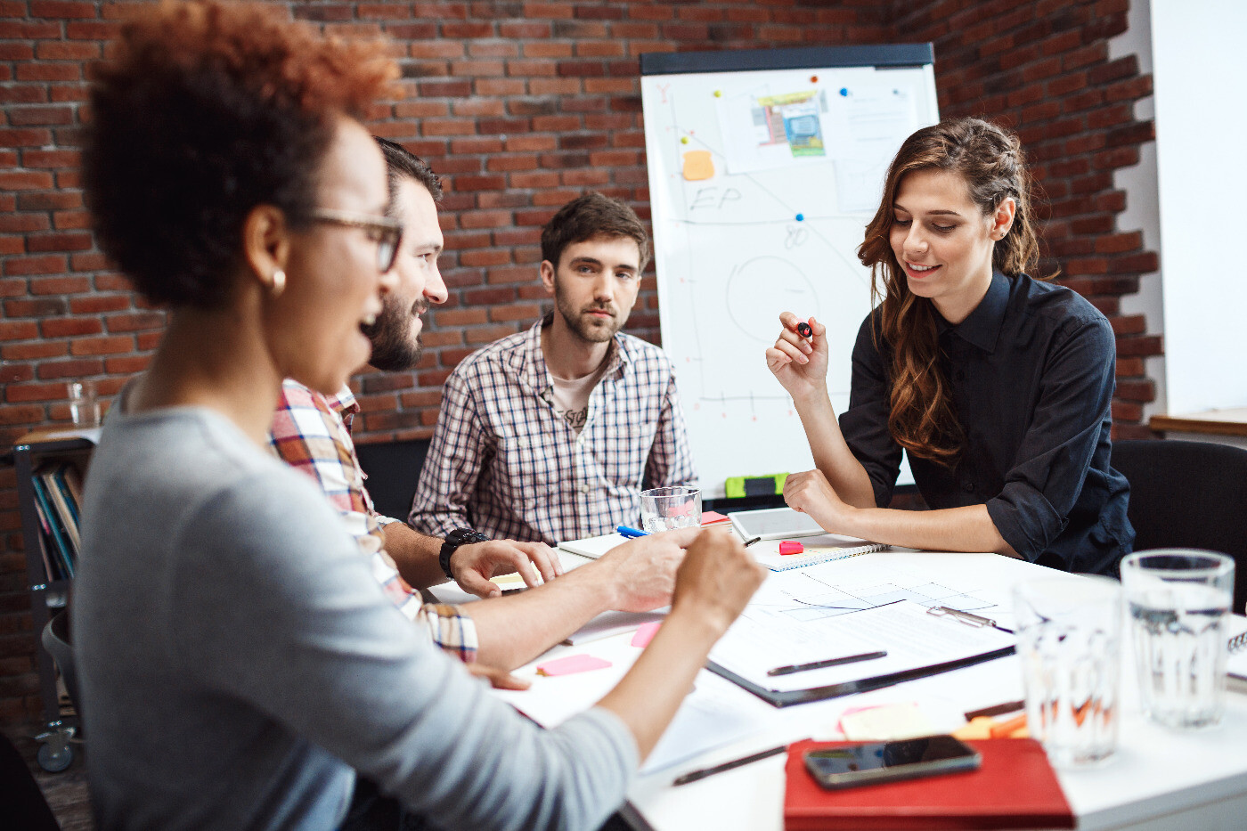 Business associates discussing role of ads during a meeting