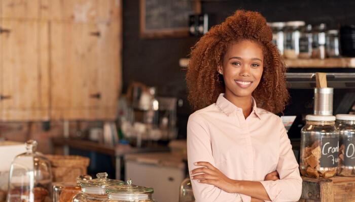 Woman standing in foreground of small business bakery