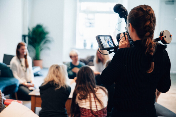 Videography professional filming people attending an event