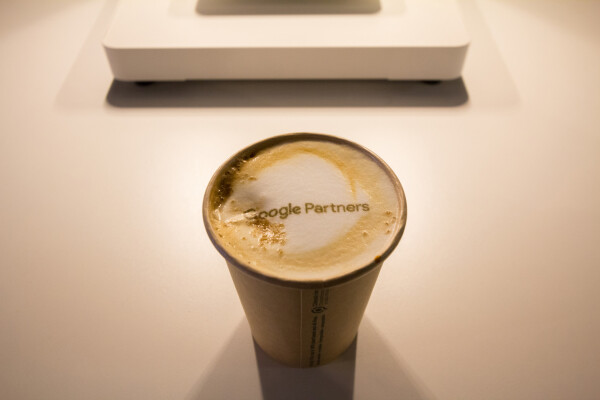 Coffee with foam spelling "Google Partners"