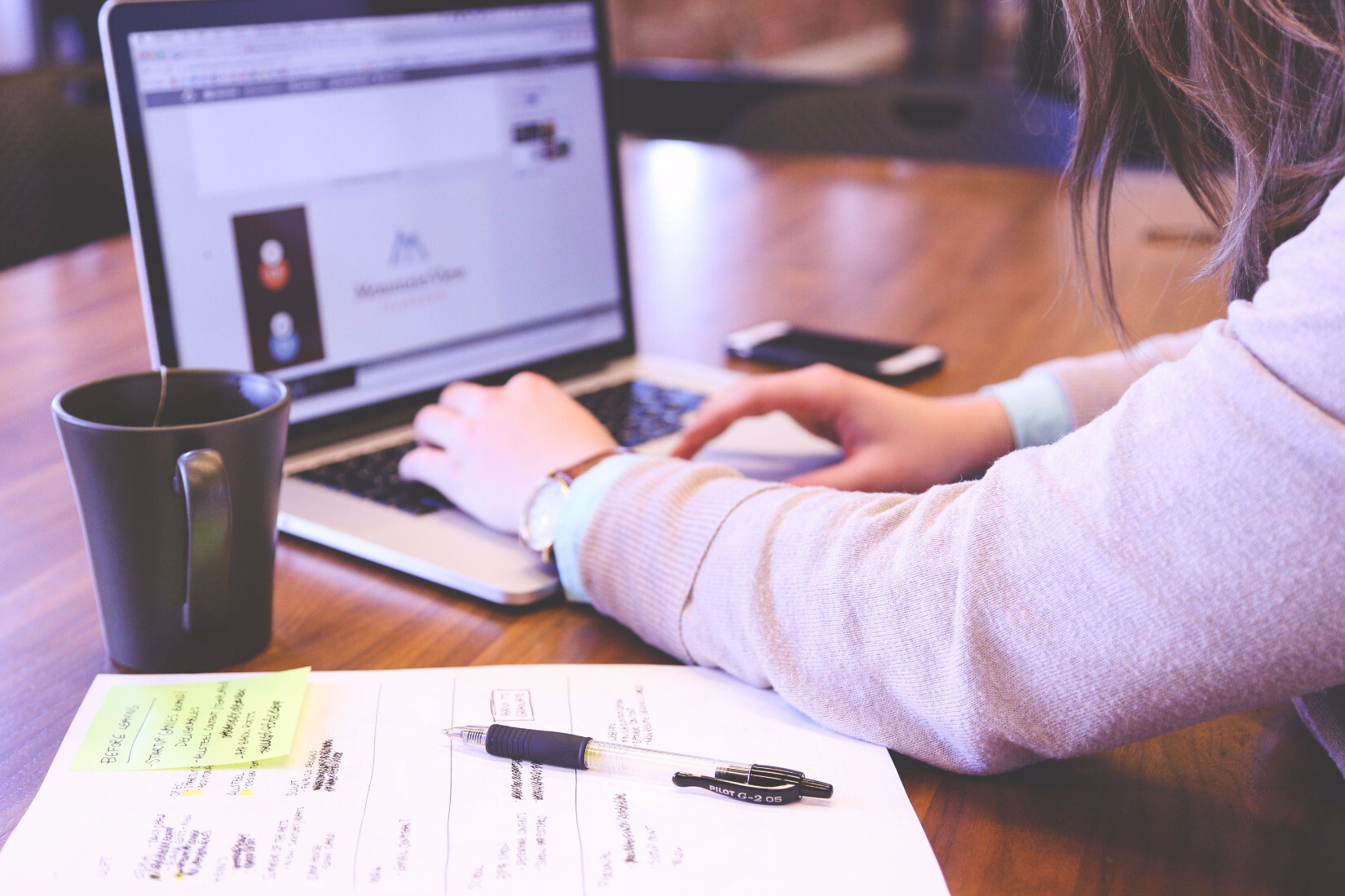 Woman working on company website on laptop