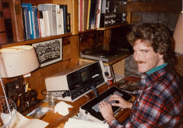 Person smiling suspiciously at camera while engaging in shady SEO tactics on vintage computer