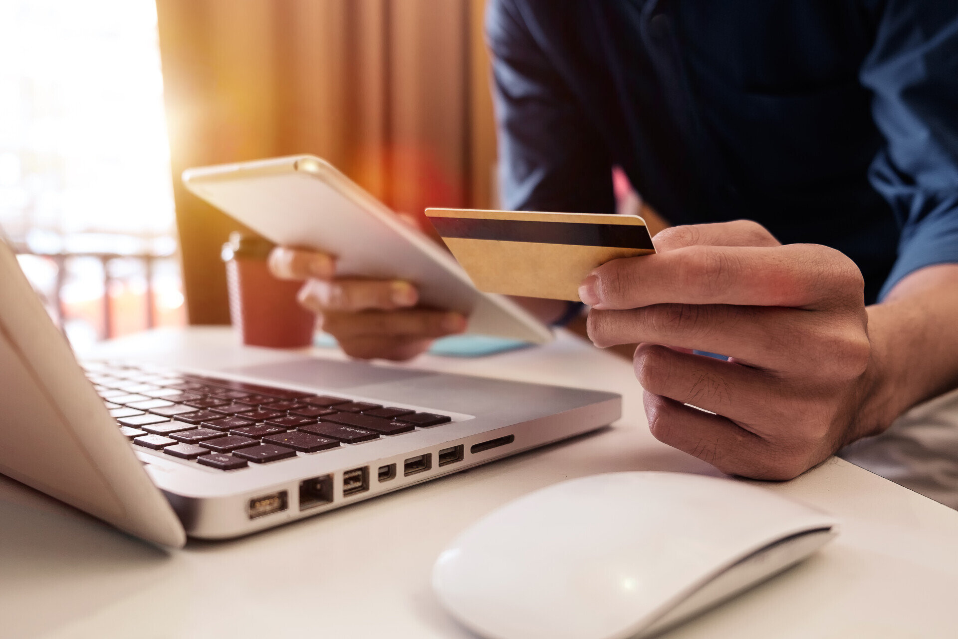 Man ordering something online with credit card in hand