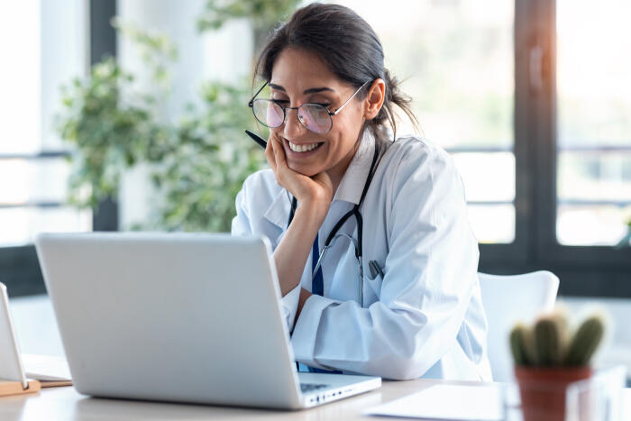 Doctor happy looking at a computer