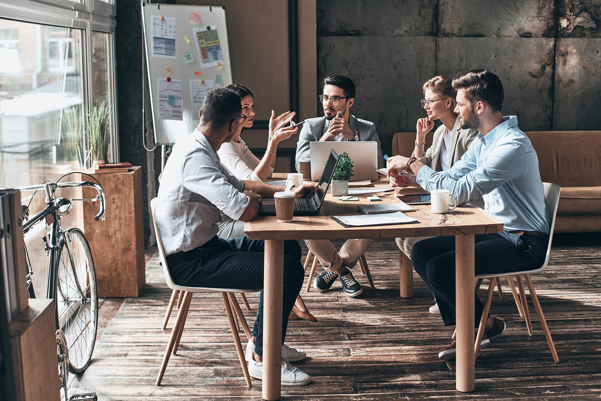 Digital marketing team gathered around table to discuss brand design